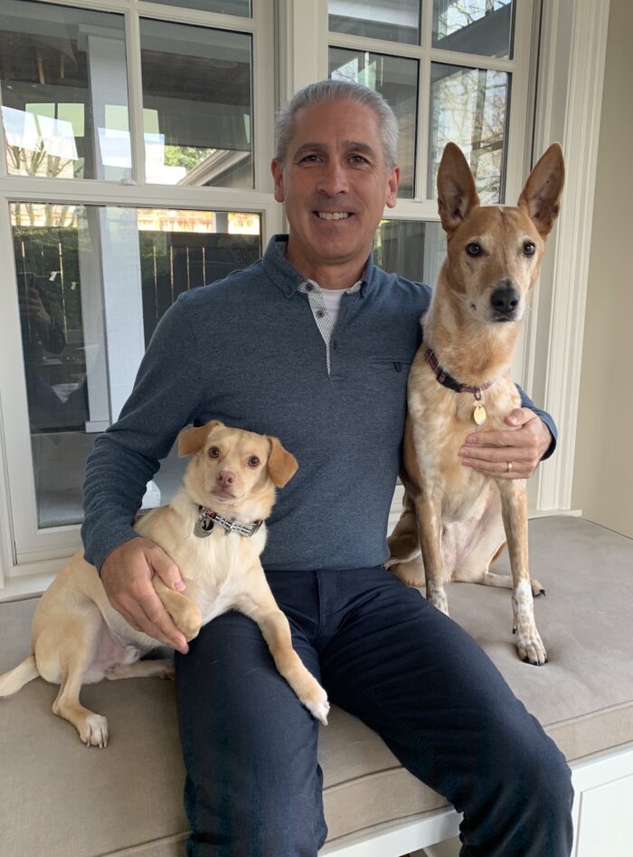 Phil Sorgen sits with his Seattle Humane alumni dogs Joey and Gracie. 