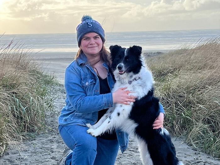 A woman with her dog at the beach